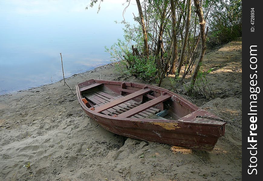 Old wooden boat on river coast