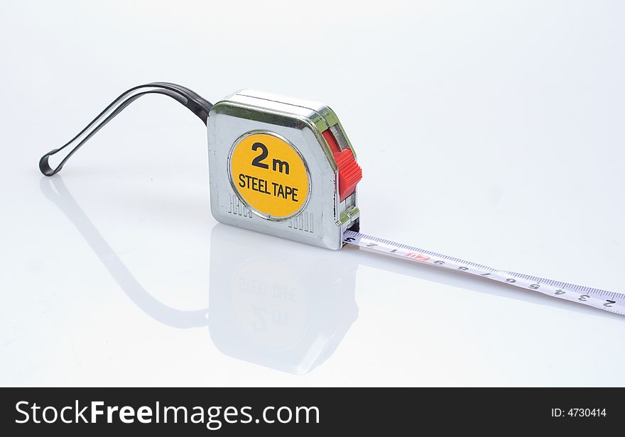 Tape measure over a white surface