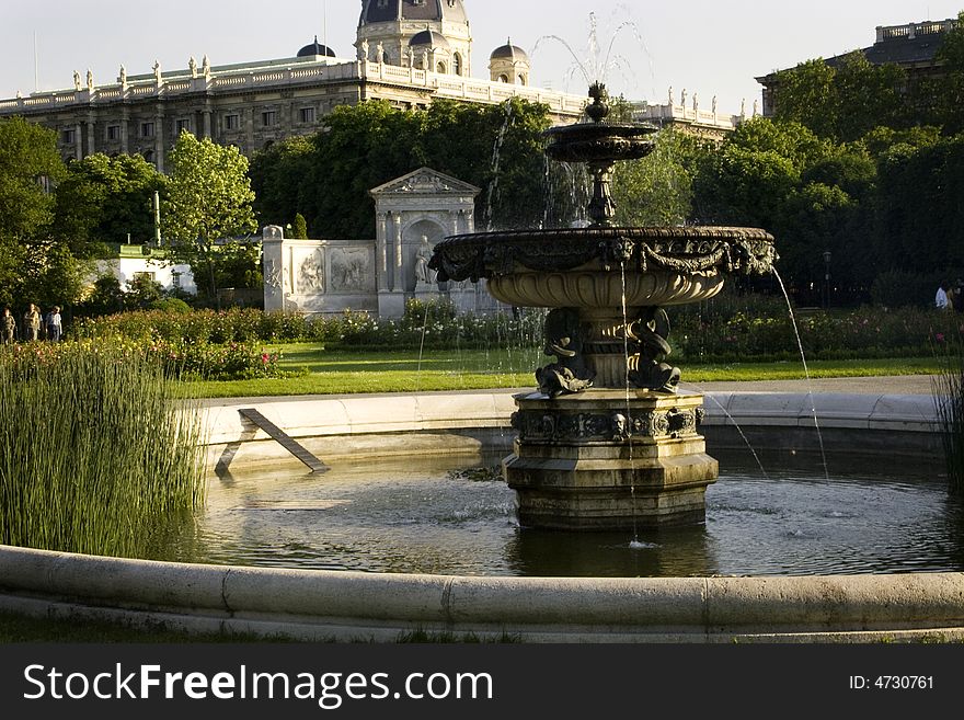 A fountain in the middle of a park on a sunny day in vienna, austria. A fountain in the middle of a park on a sunny day in vienna, austria