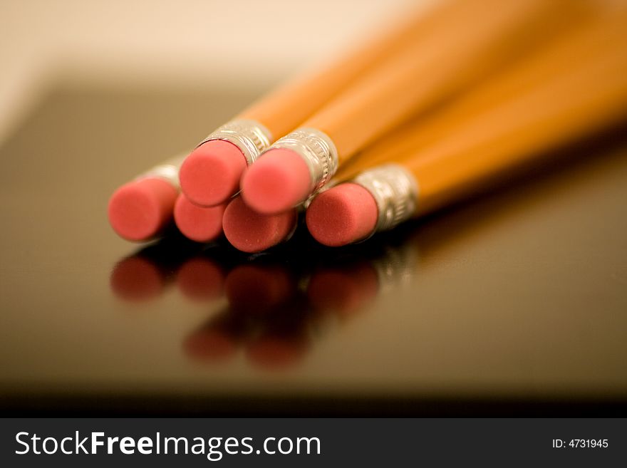 Erasers on Wood Pencils v1 are captured using depth of field with a reflection and nice perspective.