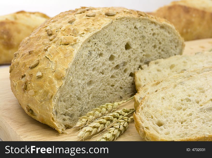 Fresh bread loaf and baguette with wheat ears