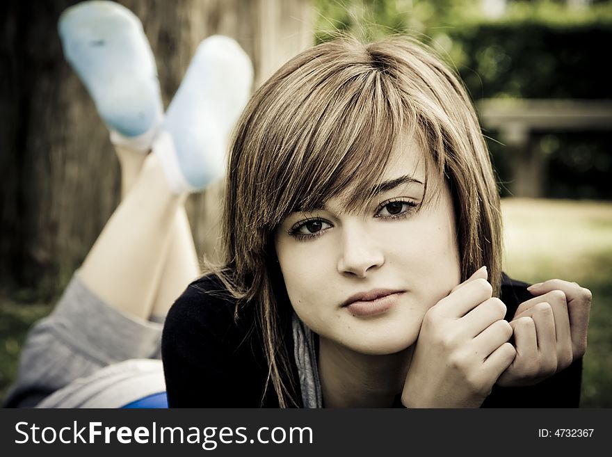 Beautiful young woman resting in the park. Beautiful young woman resting in the park.