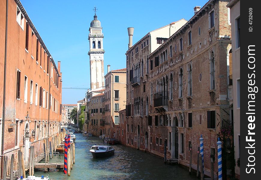 The canal is a usual Venetian canal, and the old shabby buildings are typical for the city as well. And there are several falling bell towers in Venice, because the ground is not steady enough. This tower belongs to the church San Giorgio dei Greci. The canal is a usual Venetian canal, and the old shabby buildings are typical for the city as well. And there are several falling bell towers in Venice, because the ground is not steady enough. This tower belongs to the church San Giorgio dei Greci.