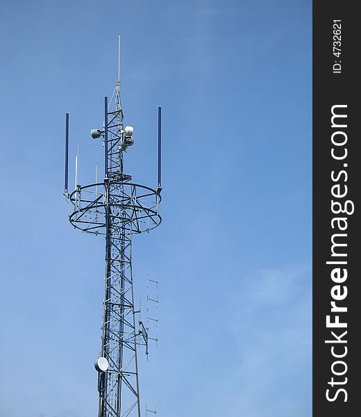 Communication tower in front of blue sky