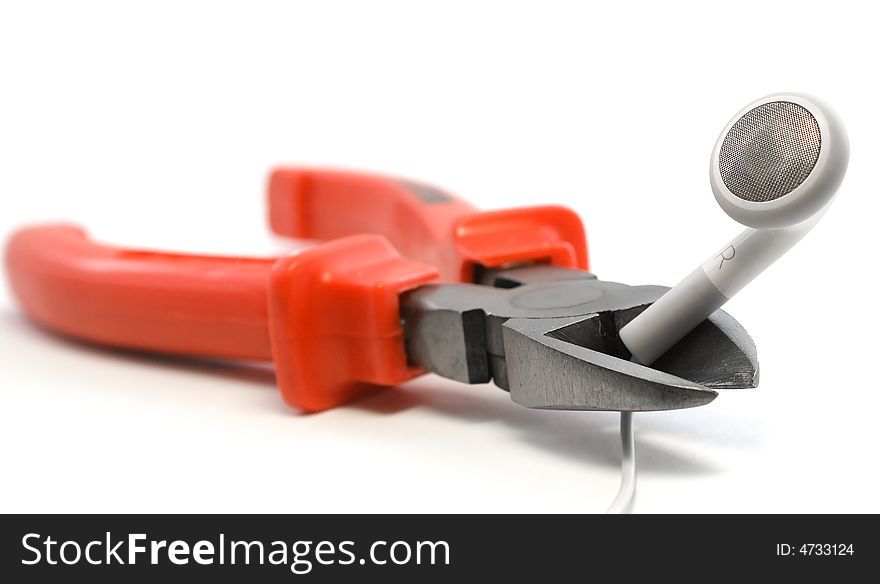 Red cutters dangerously holding white earphone wire on white background. Red cutters dangerously holding white earphone wire on white background