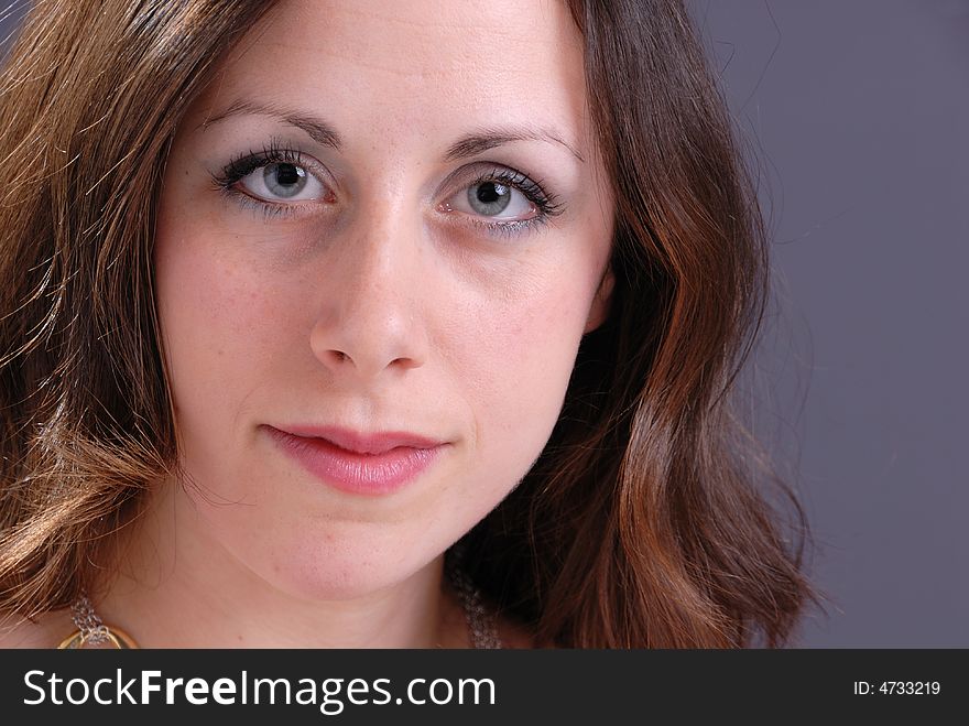 Portrait of attractive young lady on grey background