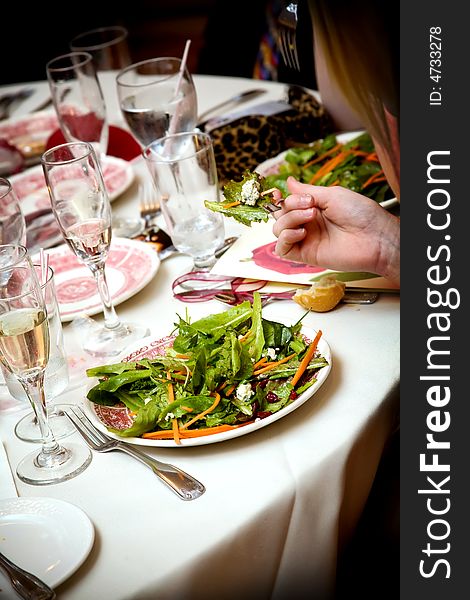 Salad is served during a wedding celebration. Salad is served during a wedding celebration