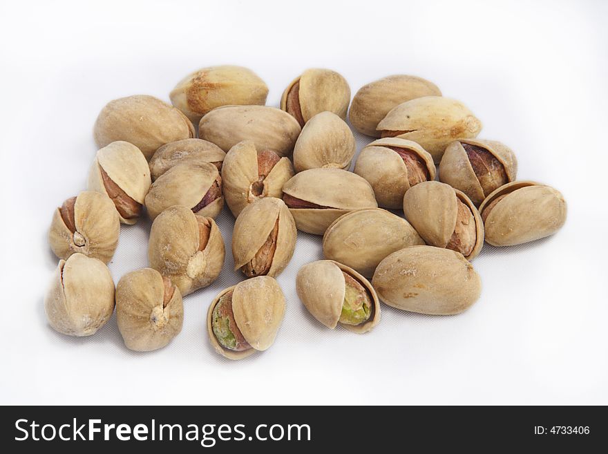 Opened pistachioes on white background