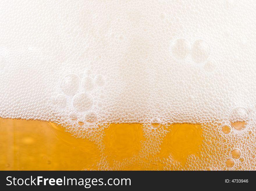 Background from fresh foamy beer with bubbles. Close-up. Background from fresh foamy beer with bubbles. Close-up.