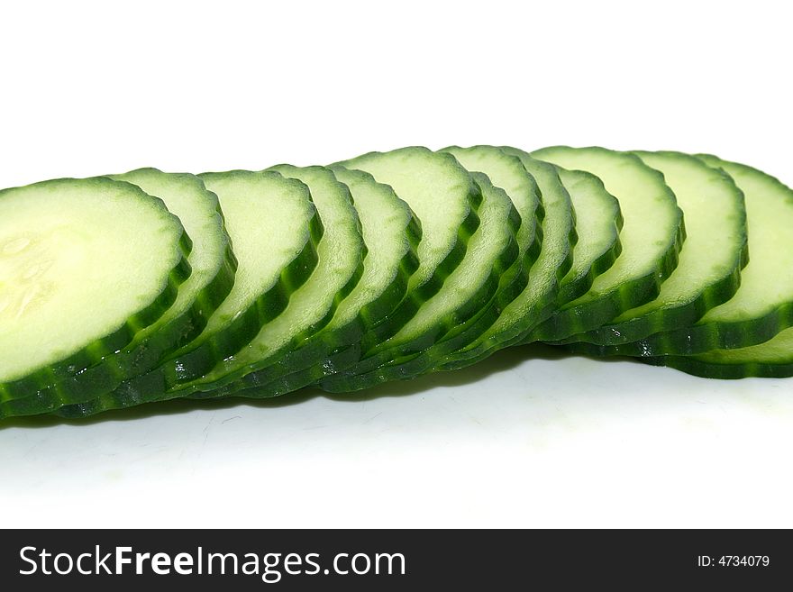 A row of cut cucumber slices. A row of cut cucumber slices