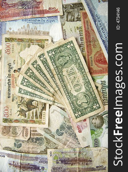 Cambodian Riels underneath American dollars. Cambodian Riels underneath American dollars