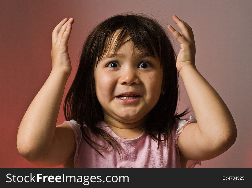 Young girl holding her hands in the air looking surprised. Young girl holding her hands in the air looking surprised