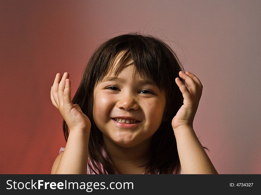 Young girl holding her hands in the air looking happy. Young girl holding her hands in the air looking happy