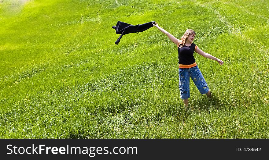 Young woman playing on green field. Young woman playing on green field.