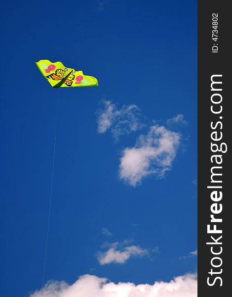 Green kite against blue sky. Green kite against blue sky