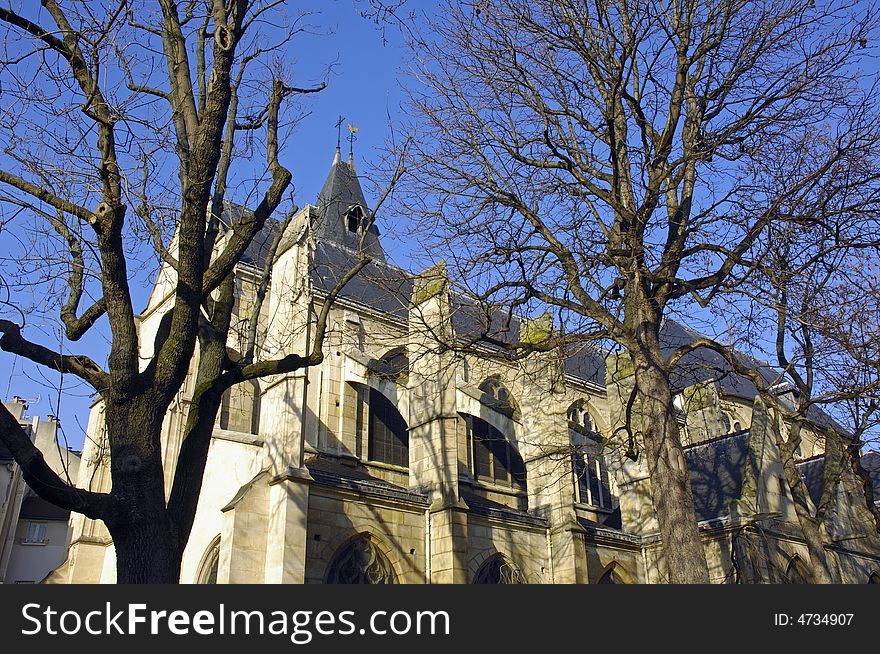 France; Paris; winter view with architecture; the St. Medare church and some bared trees. France; Paris; winter view with architecture; the St. Medare church and some bared trees