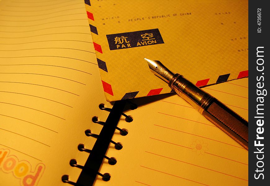 Notepad, pen and air postal envelope