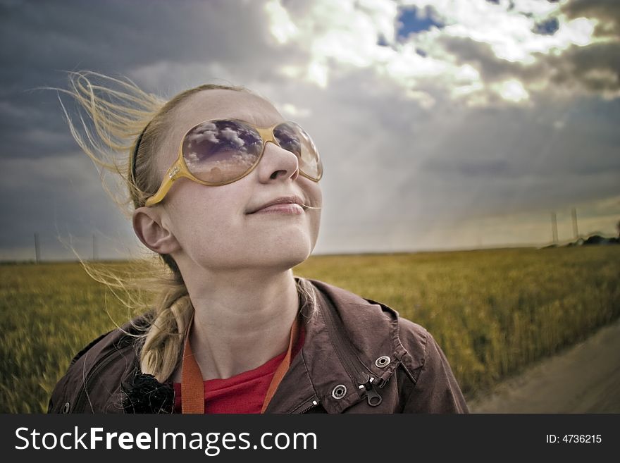 Outdoor portrait of young smiling blonde woman with sunglasses. Outdoor portrait of young smiling blonde woman with sunglasses