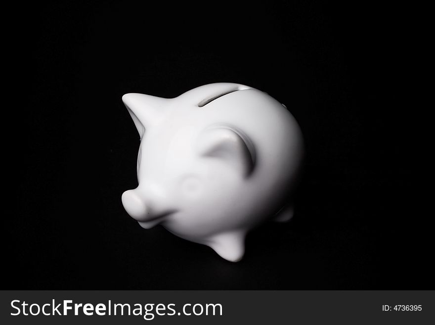 Elegant white piggy bank isolated on black