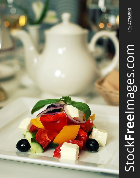 Healthy green salad on white plate in luxury restaurabt. Healthy green salad on white plate in luxury restaurabt