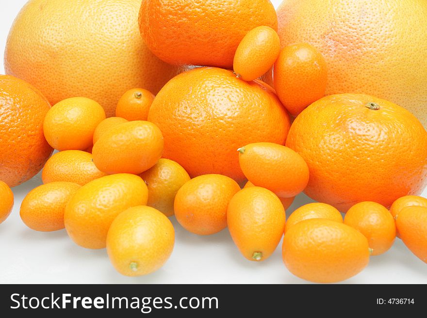 Citrus fruits on a white glass table