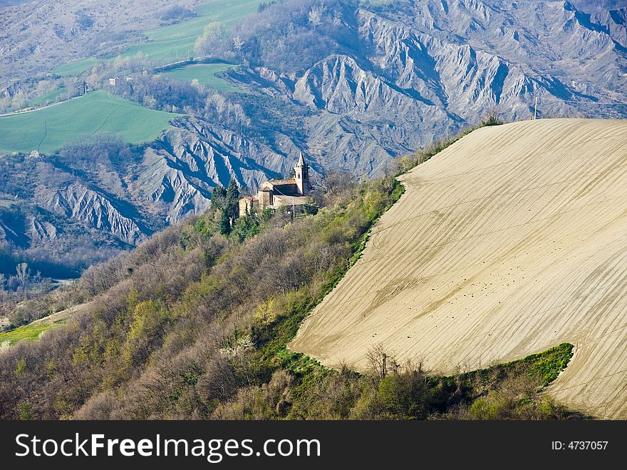 Solitary church on the hillside in the Aemilian countryside, Emilia, Italy