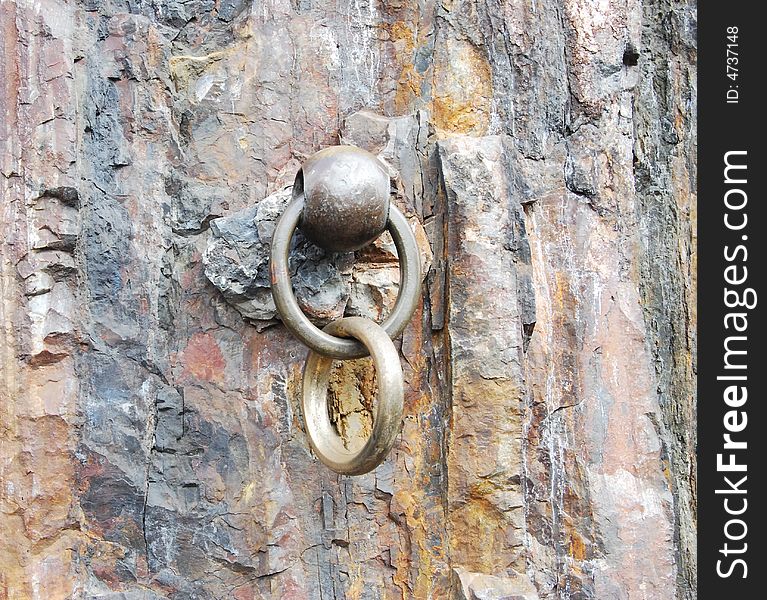 Vintage metallic ring is in a rock