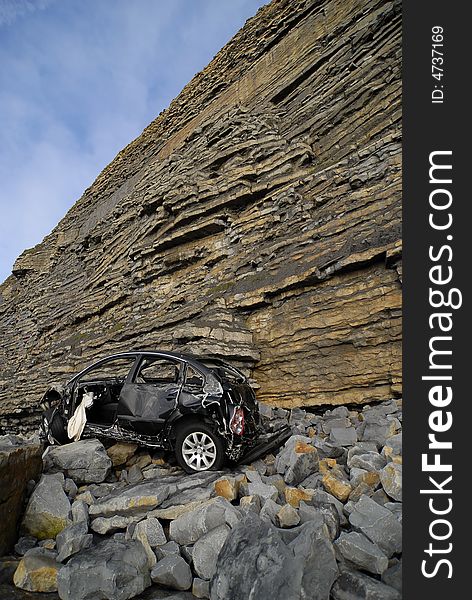 Car at bottom of cliff. Car at bottom of cliff