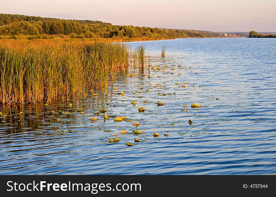 Beautiful and picturesque water landscape in summer - sunset over the river. Beautiful and picturesque water landscape in summer - sunset over the river