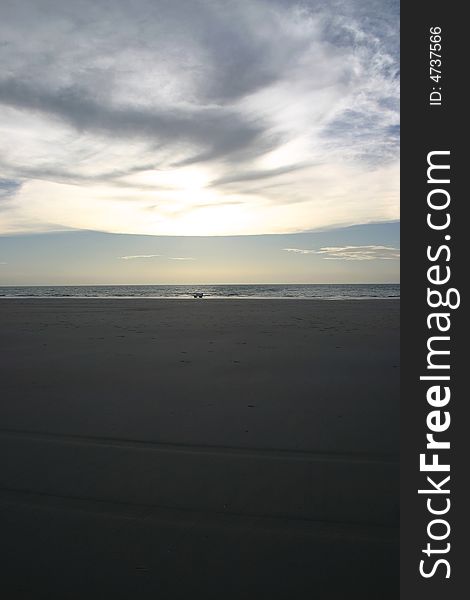 Silhouette of a car driving on a sandy beach. Australia. Silhouette of a car driving on a sandy beach. Australia.