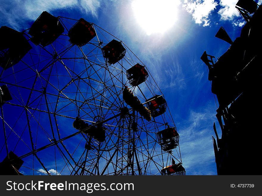 A ferris wheel taken againt a blue background, background has been darkened in CS3. A ferris wheel taken againt a blue background, background has been darkened in CS3