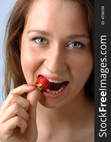 Woman with berry in mouth