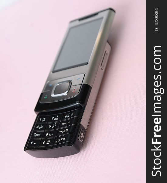 A modern 3g handphone on pink