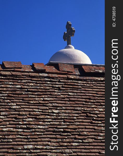 A simple frame with cross , roof and blue sky