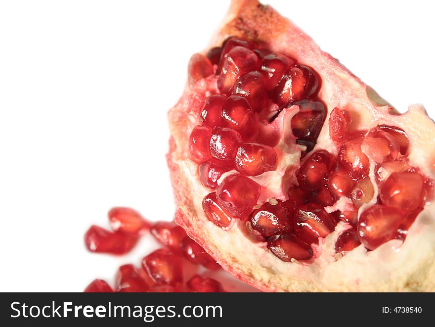 Pomegranate and kernels on a white background