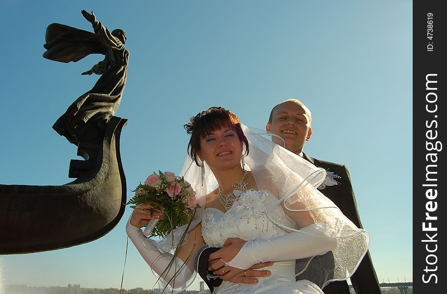 Newly wedded couple walking on the park