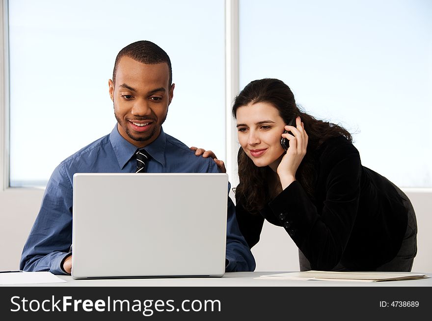 Male and female business partners in a window office. Male and female business partners in a window office