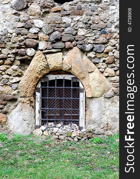 Old stone wall with bricks and window. Old stone wall with bricks and window