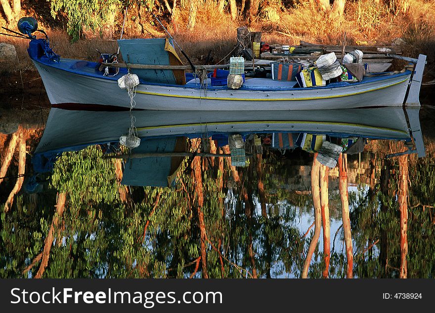 A reflection fishing boat in a river. A reflection fishing boat in a river