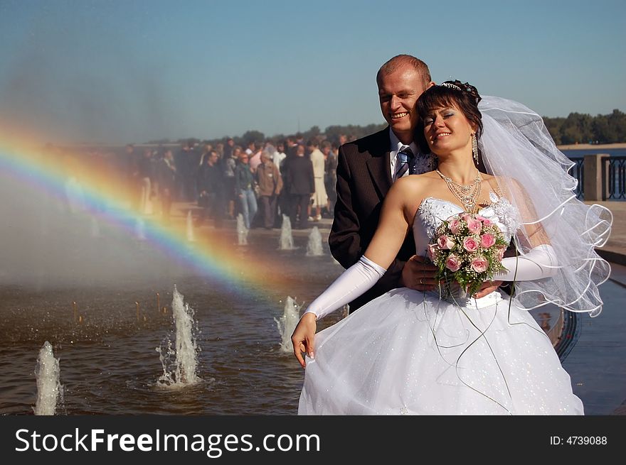 Newly wedded couple walking on near the river