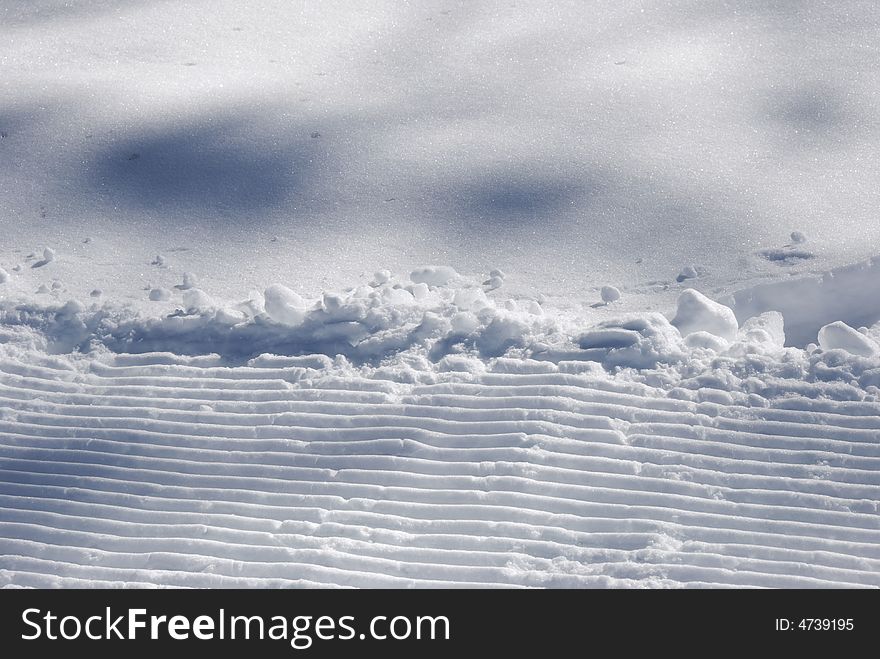 Parallel strips in the snow - in blue light