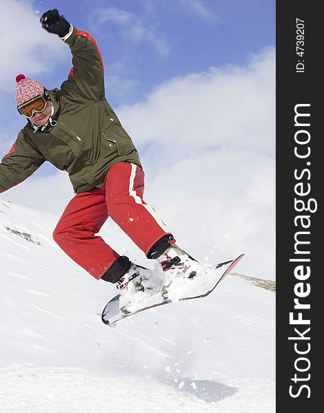 Snowboarder taking a jump in fresh snow