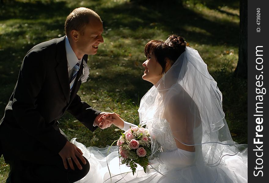 Newly wedded couple on the grass