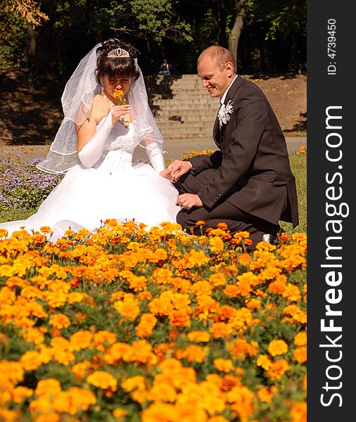 Portrait of a newly wedded couple playing on the park