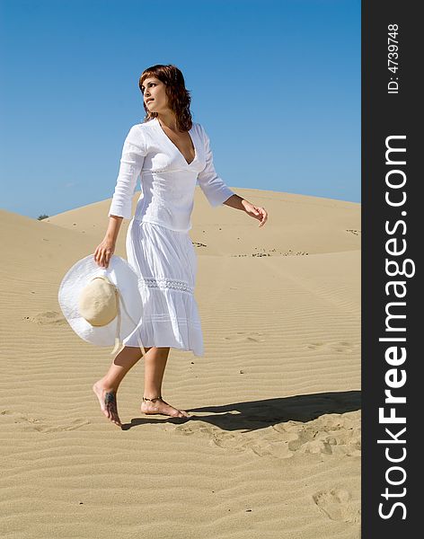 Beautiful Woman With Hat In The Desert