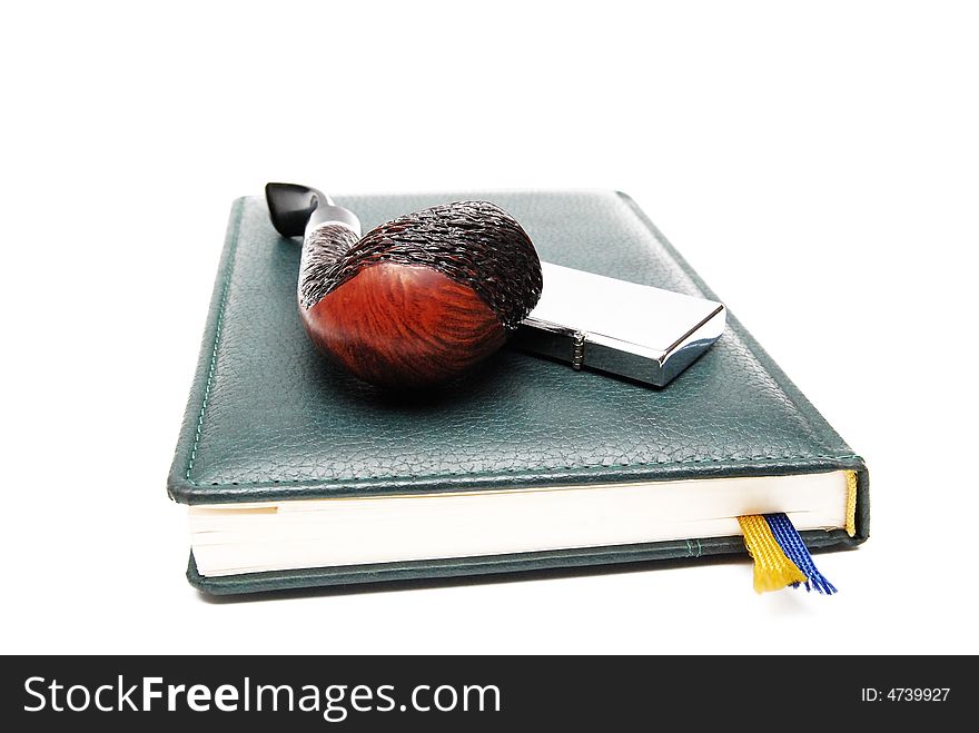 Diary and tobacco-pipe on a white background