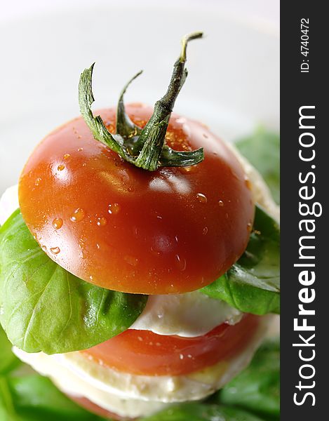 Insalata caprese: tomatoes, mozzarella and basil on a plate