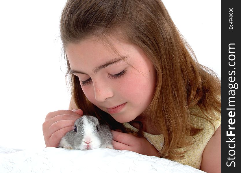 School aged girl petting soft gray bunny