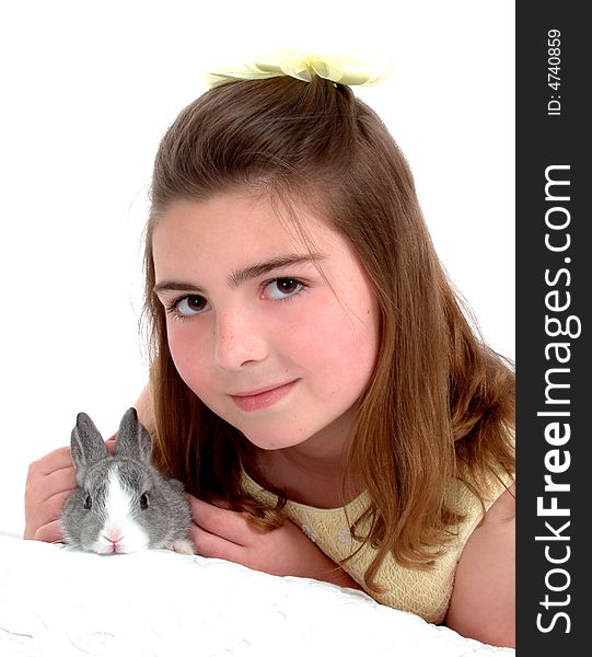 School aged girl gently petting soft gray bunny. School aged girl gently petting soft gray bunny