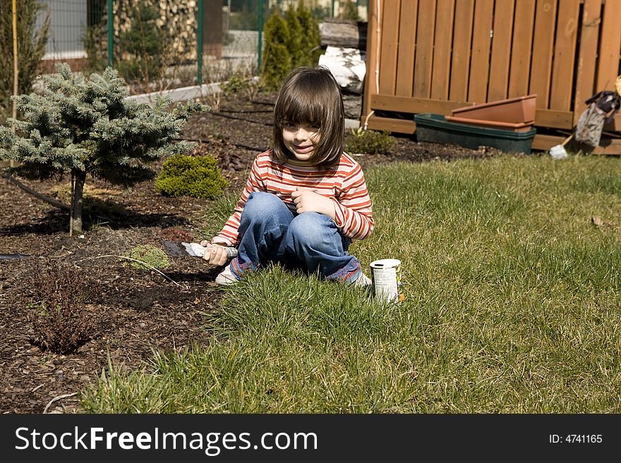 Young child gardener it plants